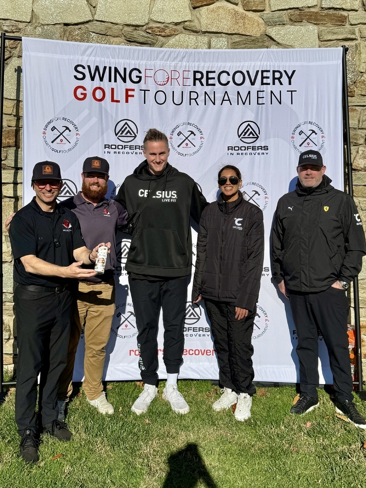 A team poses with Steve Spence at the Swing Fore Recovery golf tournament.