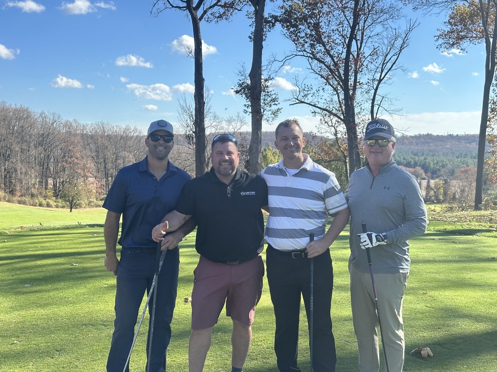 A team poses at the Swing Fore Recovery charity golf tournament.